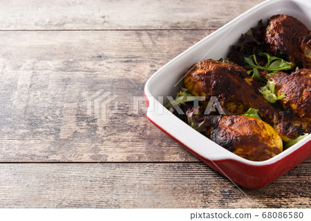 Roasted tandoori chicken with basmati rice on wooden table	 68086580