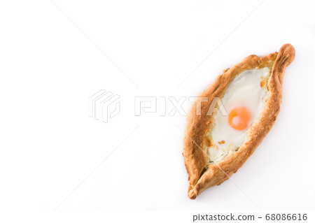 Traditional Adjarian Georgian khachapuri with cheese and egg isolated on white background. Top view 68086616
