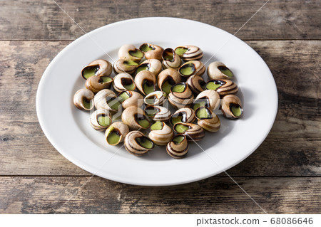 Escargots de Bourgogne on wooden table	 68086646