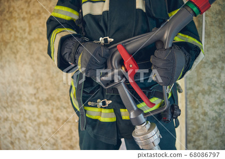 Portrait of man hands with water hose 68086797