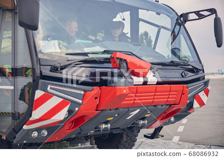Rescue team sitting in the red fire engine 68086932