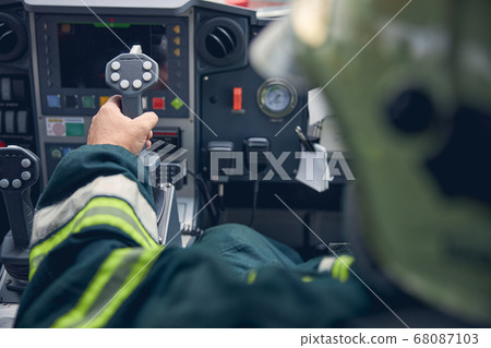 Man putting arm on the dashboard of truck while managing it 68087103