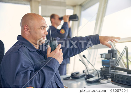 Confident Caucasian senior man talking on the walkie 68087904