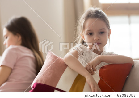 Upset kid daughter feeling sad after fight with mother 68088395