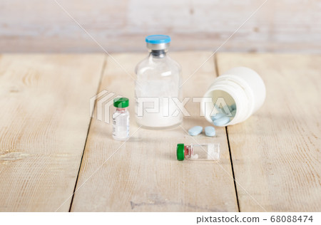 Various pill bottles and different pills on wooden table Various pill bottles and different pills on wooden table 68088474
