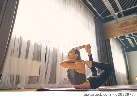 Beautiful serene woman practicing yoga in studio 68088975