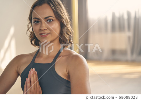 Cheerful young woman practicing yoga in studio 68089028