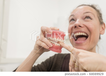 Funny woman playing with jaws in dentist clinic 68089929