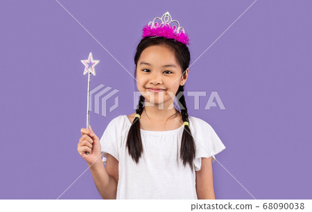 Japanese Girl Wearing Crown Holding Magic Stick Over Purple Background 68090038