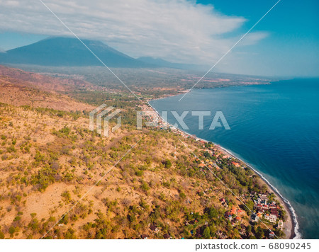Aerial view of Amed village with sea, boats and volcano in Bali 68090245