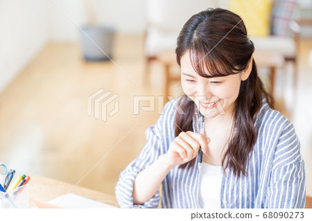 Young woman doing remote work in the living room. Young woman doing remote work in the living room. 68090273