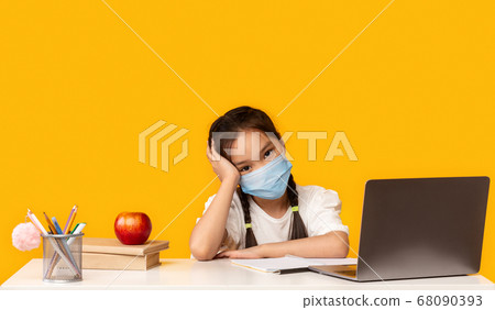 Chinese Girl At Laptop Wearing Mask Studying Online, Yellow Background 68090393