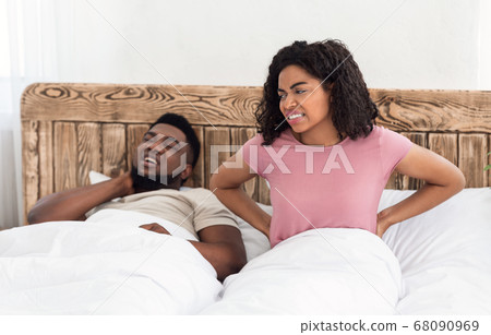 Black married couple having body pain in morning 68090969