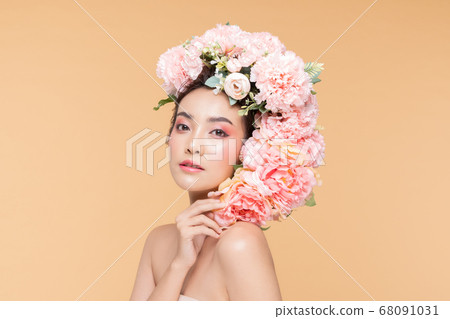 Beauty Asian young woman with big bouquet flowers on head smile with clean fresh skin Happiness and cheerful with positive emotional on Beige background,Beauty Cosmetics and Facial treatment Concept 68091031