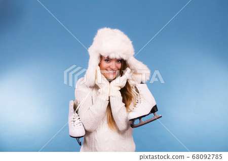 Woman with ice skates getting ready for ice 68092785