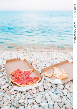 Fresh pizza on the beach background of the sea Fresh pizza on the beach background of the sea 68093051