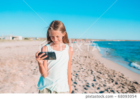 Adorable little girl at beach during summer vacation Adorable little girl at beach during summer vacation 68093054