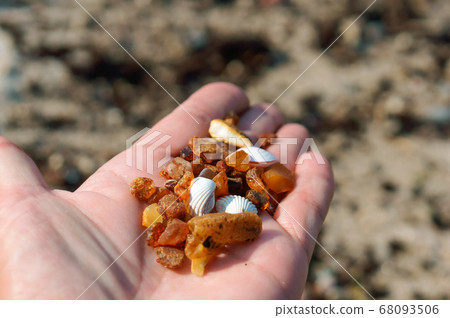 amber gemston, small stones of amber in the palm amber gemston, small stones of amber in the palm 68093506