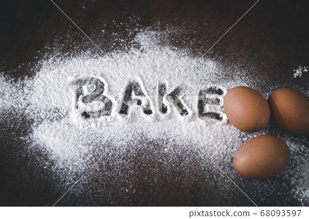 Conceptual still life photo of eggs and flour spilled on a table to show concept of baking as a way to support mental health and coping during home quarantine due to covid-19 pandemic 68093597
