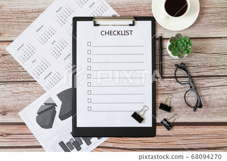 Blank Checklist on wooden desk with coffee, glasses, calendar, plants 68094270