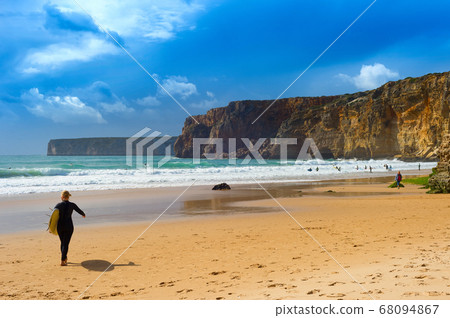 Surfer surfboard woman Portugal beach Surfer surfboard woman Portugal beach 68094867