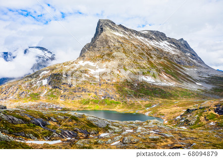 Snow mountain peak around Alnesvatnet lake 68094879