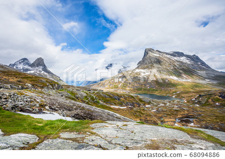 Passage in the mountains with snowy peaks around 68094886