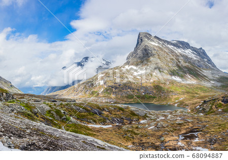 Passage in the mountains with snowy peaks around 68094887