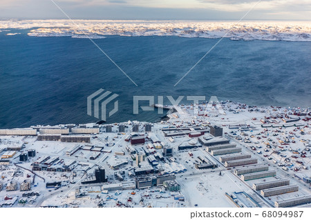 Aerial view to the fjord and snow streets of 68094987