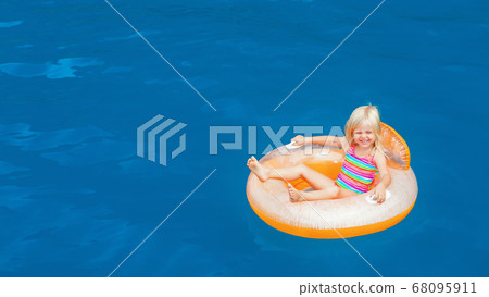 Child swimming with fun on inflatable floating 68095911