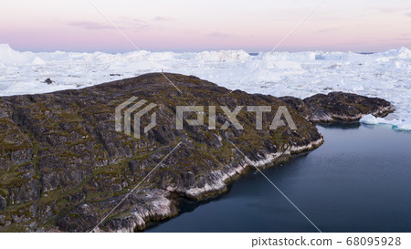 Arctic landscape nature with icebergs and ice in Greenland icefjord. Aerial drone image of ice and iceberg. Ilulissat Icefjord with icebergs from Jakobshavn Glacier aka Sermeq Kujalleq glacier 68095928