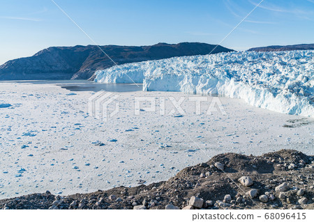 Climate Change Concept. Greenland Glacier heavily affected by Global Warming. Glacier front of Eqi glacier in West Greenland AKA Ilulissat and Jakobshavn Glacier. Produces many of Greenlands icebergs 68096415