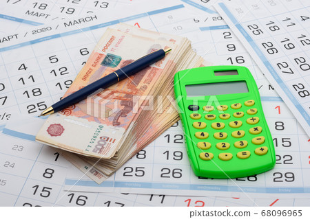 There is a wad of money on the calendar, a 68096965