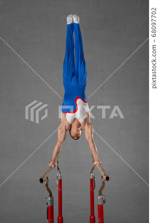 gymnast performs a stand on his hands gymnast performs a stand on his hands 68097702