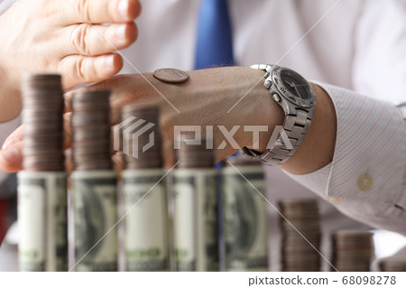 Man put coin on back his hand, counting money 68098278