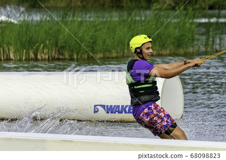 Teenager wakeboarding on a lake - Brwinow, Masovia, Poland 68098823