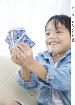 Boys playing on playing cards Boys playing on playing cards 68100943