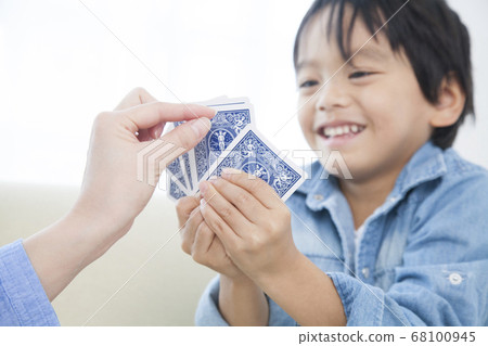 Parents and children playing with playing cards Parents and children playing with playing cards 68100945