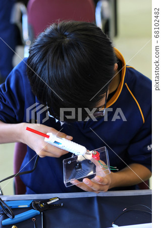 Junior high school students who work with glue guns Junior high school students who work with glue guns 68102482