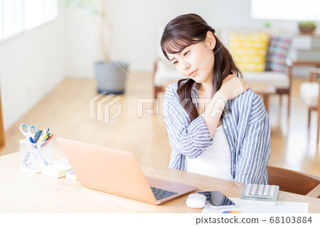 A young woman doing telework in the living room. A young woman doing telework in the living room. 68103884