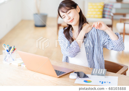 A young woman doing telework in the living room. A young woman doing telework in the living room. 68103888