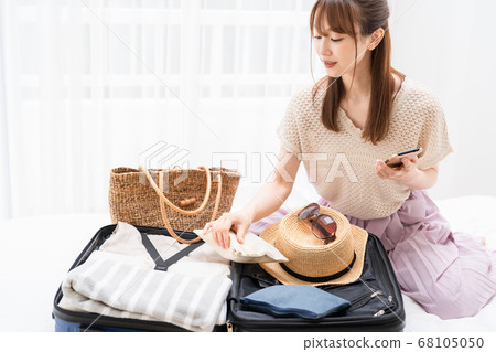 Young woman preparing for an excursion Young woman preparing for an excursion 68105050