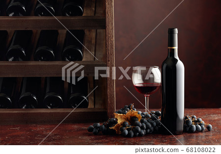 Red wine and grapes on a brown background. 68108022