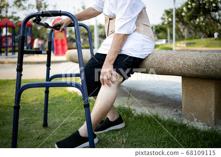 Tired asian senior woman with leg,knee pain,touch her knee pain,female elderly with acute knee joint pain,bone problem,physical injury,exhausted old people suffering from gout,arthritis,rheumatism 68109115