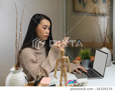 Portrait of female working with smartphone, mock 68109139