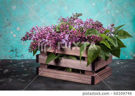 Lilac flowers bouquet on wooden box on black concrete background. Stylish floral greeting card. Happy mothers day. 68109746