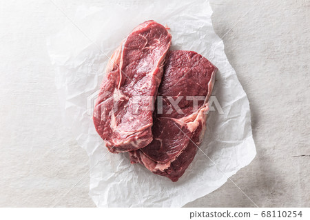 Two beef Rib eye steaks on white concrete table - Two beef Rib eye steaks on white concrete table - 68110254