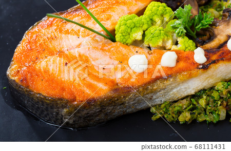 Fried salmon steak with broccoli Fried salmon steak with broccoli 68111431