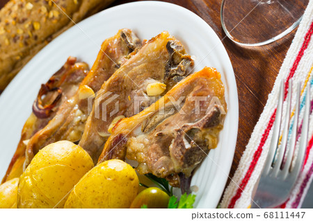 Roasted lamb ribs with potato Roasted lamb ribs with potato 68111447