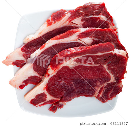 Raw beef entrecotes on plate Raw beef entrecotes on plate 68111837